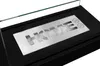 A close-up view of a black freestanding bio-fireplace with a metal insert featuring the word "HOME" cut out. Produktbild-Vorschau