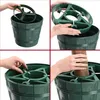 A collage of four images showing the assembly of a green Christmas tree stand. Voir les images du produit