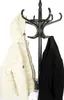 A black coat rack with a cream-colored jacket and a black coat hanging on it. Anteprima dell’immagine prodotto