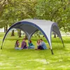A group of people sitting under a canopy in a park. Anteprima dell’immagine prodotto