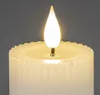 Close-up of the top of a white LED candle with a flickering flame. Produktbild-Vorschau