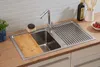 A kitchen sink area with a faucet, cutting board, and drying rack. Produktbild-Vorschau