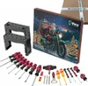 A collection of Wera tools, including screwdrivers, a bottle opener, and bits, arranged in front of a Christmas-themed advent calendar featuring Santa on a motorcycle. Podgląd zdjęcia produktu