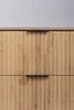 A close-up view of two drawers of a wooden cabinet with black handles. Produktbild-Vorschau