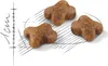 Three pieces of brown kibble are arranged on a white background with a sketch of lines and a ruler. Produktbild-Vorschau