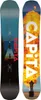 Two snowboards are shown side-by-side, one with a blue and black design featuring a geometric image, and the other with a vibrant orange and yellow explosion graphic. Voir les images du produit