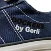 A close-up view of a blue denim sneaker with white stitching and branding. Voir les images du produit