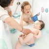 A mother and two children are in a bathtub, with the mother assisting the baby. Podgląd zdjęcia produktu