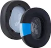 Two black ear pads for headphones are shown against a white background. Voir les images du produit