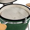 Close-up view of the interior of a green ceramic kamado grill with a stainless steel cooking grate. Produktbild-Vorschau