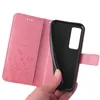 A hand holding a pink floral flip phone case open, revealing the black interior where a phone would be placed. Produktbild-Vorschau
