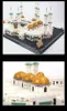 A close-up view of a Lego model of the Great Mosque of Mecca, focusing on the golden domes and white minarets. Produktbild-Vorschau