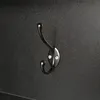 A close-up shot of a black metal coat hook mounted on a textured black surface. Anteprima dell’immagine prodotto