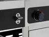 A close-up view of a gas grill's control panel and a bottle opener. Produktbild-Vorschau