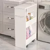 A white rollwagen with cleaning supplies is placed next to a washing machine and a dresser. Voir les images du produit