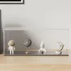 A clear acrylic display case containing four decorative items: an astronaut figurine, a speckled globe, a rocket ship, and a crescent moon. Náhled obrázku produktu