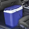A blue cooler box is placed on the floor of a car, next to a car seat. Produktbild-Vorschau