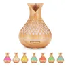 A large wooden-patterned aroma diffuser with a decorative lattice design is shown in the center, with seven smaller versions of the diffuser in various colors displayed below it. Produktbild-Vorschau