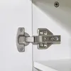 A close-up view of a cabinet hinge attached to a white cabinet door. Anteprima dell’immagine prodotto