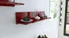 A red high-gloss shelf mounted on a white wall, decorated with a white vase, decorative balls, and candles. Produktbild-Vorschau