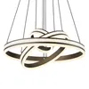 A modern, multi-ringed chandelier with integrated LED lighting, suspended by thin wires against a white background. Produktbild-Vorschau