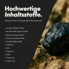 A dark background with white text listing ingredients, next to a close-up of a dark, rough object on sand. Produktbild-Vorschau