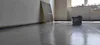 A room under construction with protective sheeting on the floor and materials leaning against the wall. Produktbild-Vorschau