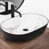 A black oval vessel sink with a marble-patterned interior sits on a wooden countertop. Náhľad obrázku produktu