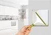 A hand is cleaning a light switch in a kitchen. Voir les images du produit