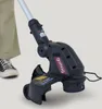 A close-up shot of a Gomag electric grass trimmer, with a person's leg and shoe visible in the background. Produktbild-Vorschau