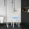 A shower stool is placed in a modern bathroom with a shower running. Produktbild-Vorschau