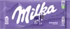A Milka Alpenmilch chocolate bar wrapper with a cow and mountains. Produktbild-Vorschau
