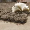 A close-up of a fluffy rug with an open book on it. Produktbild-Vorschau