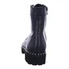 A black leather boot with studs on the sole, shown from the back. Produktbild-Vorschau
