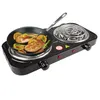 A black electric double burner hot plate with a frying pan containing fish and citrus slices on the left burner. Náhľad obrázku produktu