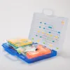 An open blue and white plastic case containing a toy drill, building blocks, and other accessories. Produktbild-Vorschau