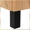 A close-up view of the corner of a wooden cabinet with a black leg. Podgląd zdjęcia produktu