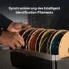 Hands interacting with a filament spool holder containing multiple spools of filament. Produktbild-Vorschau