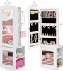 A white jewelry cabinet with a mirror, open to reveal storage for jewelry and accessories, with a shelf unit below containing toys and books. Náhľad obrázku produktu
