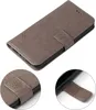 A gray flip cover phone case with a floral embossed pattern. Produktbild-Vorschau