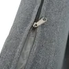 A close-up view of a zipper on a gray fabric surface. Náhled obrázku produktu