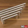Several cabinet handles of varying lengths arranged diagonally on a wooden surface. Produktbild-Vorschau