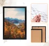 A collage of images showing a framed picture, a hand holding adhesive strips, and the back of two picture frames. Produktbild-Vorschau