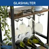 A close-up view of a wine rack with wine bottles and glasses, with a plant on the side. Produktbild-Vorschau