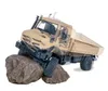 A toy Mercedes-Benz Unimog truck is shown on rocks. Produktbild-Vorschau