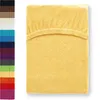 A yellow fitted sheet is shown against a white background, with a column of other color swatches to the left. Produktbild-Vorschau