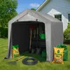 A gray storage tent filled with gardening tools and supplies, set up on a grassy lawn in front of a house. Náhled obrázku produktu