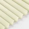 A close-up, angled view of cream-colored pleated blinds against a white background. Produktbild-Vorschau