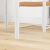 Close-up of the legs and seat of a white table with a brown cushion. Anteprima dell’immagine prodotto