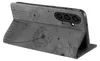 A gray flip case for a smartphone, with a dandelion design embossed on the cover, is shown partially open. Produktbild-Vorschau
